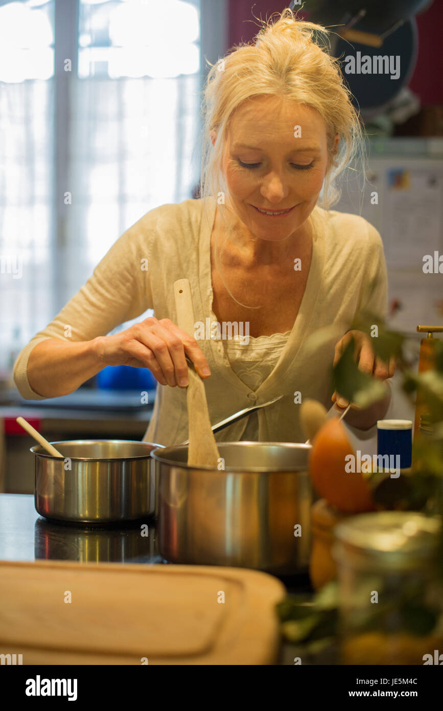 Mature woman cooking Stock Photo