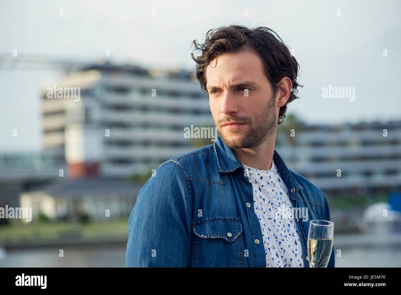 Man drinking champagne outdoors Stock Photo