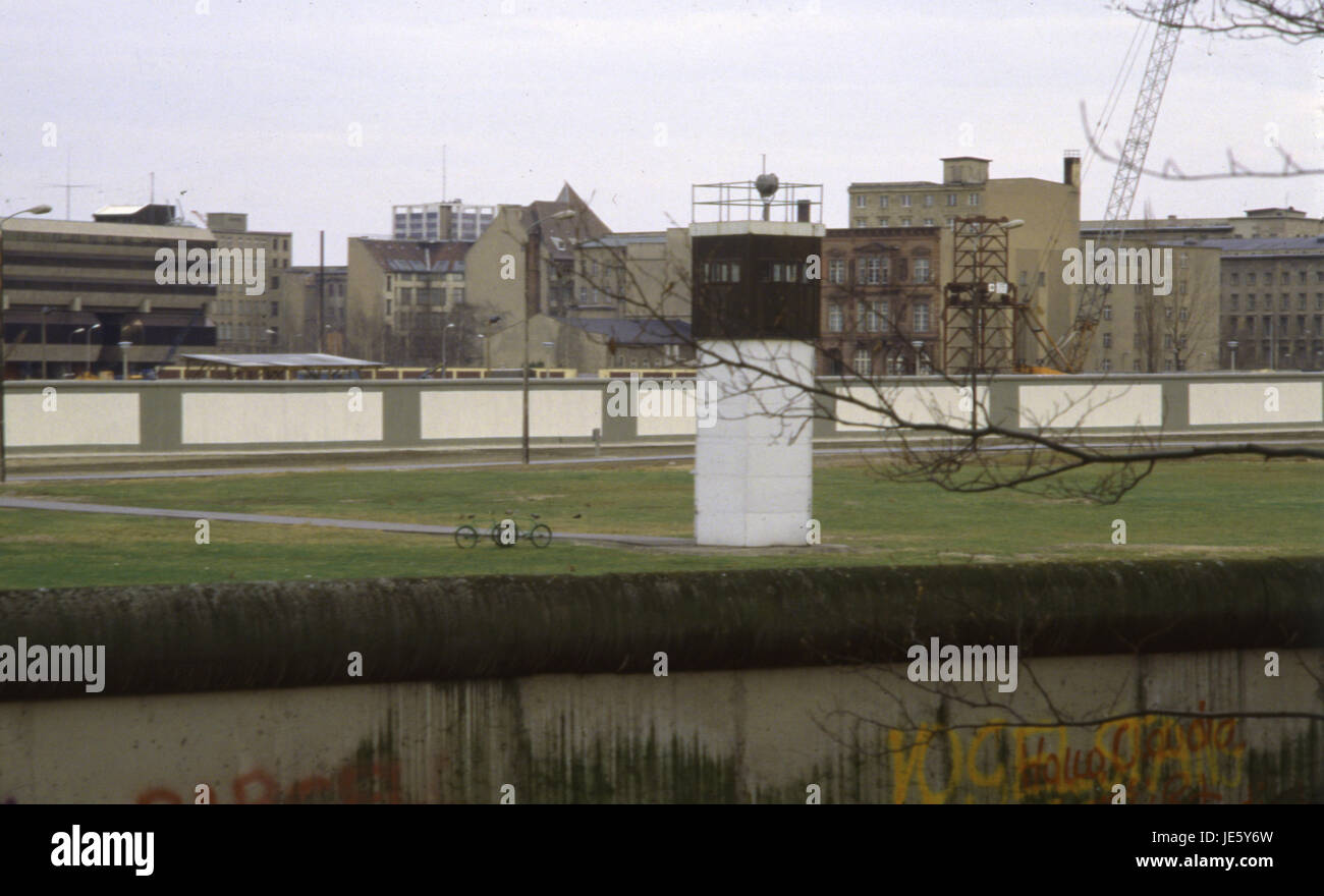 East German watch tower 1980's in Berlin with the wall in the foreground Stock Photo