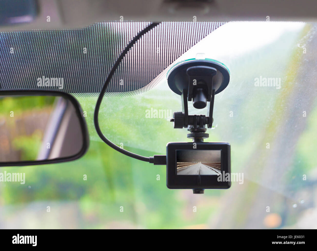 https://c8.alamy.com/comp/JE6031/dvr-camera-on-car-windshield-with-view-of-the-road-JE6031.jpg