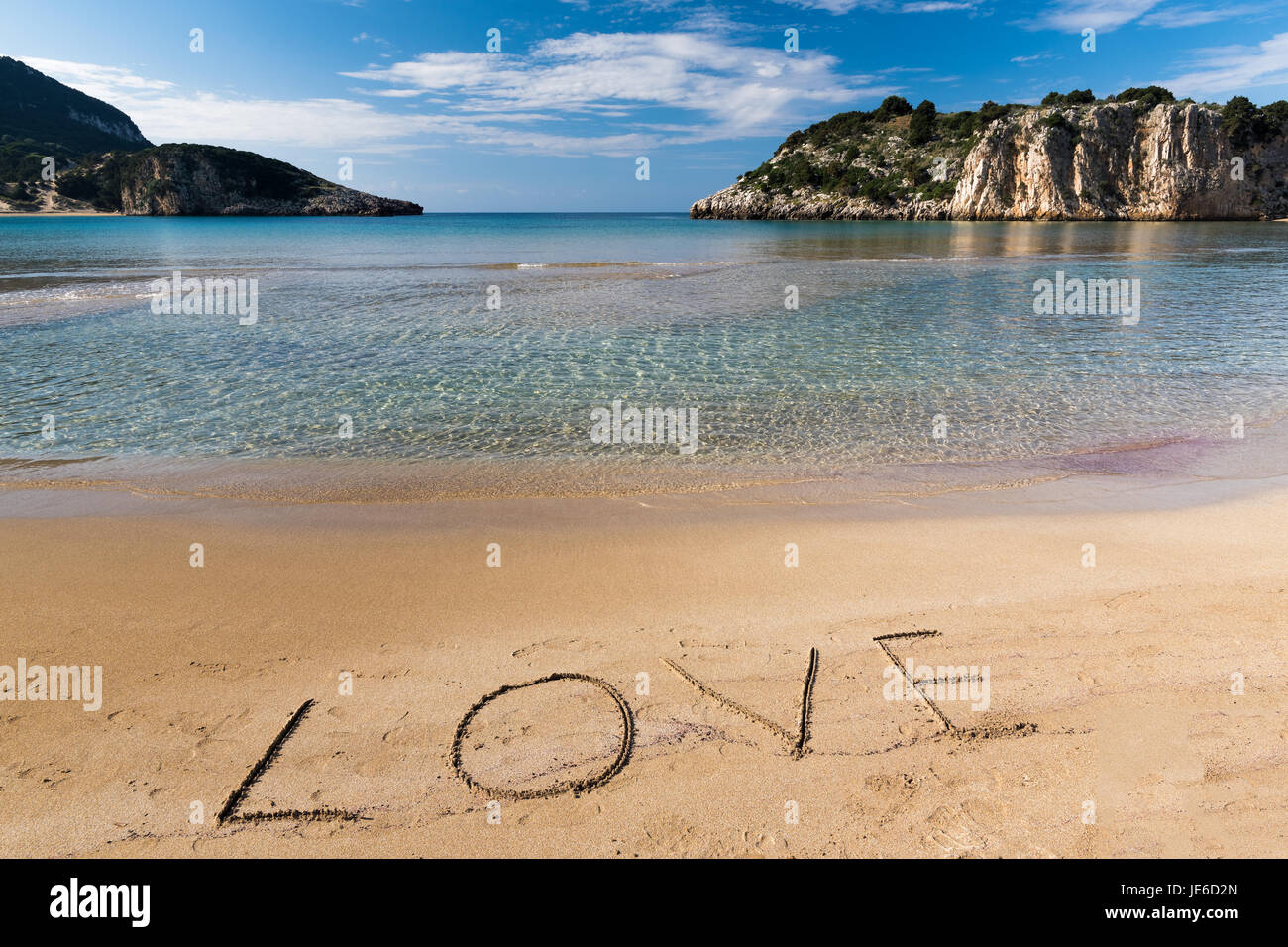 The word 'love', written on the sand of the famous Voidokilia beach in Peloponnese, one of the most beautiful beaches in Greece Stock Photo