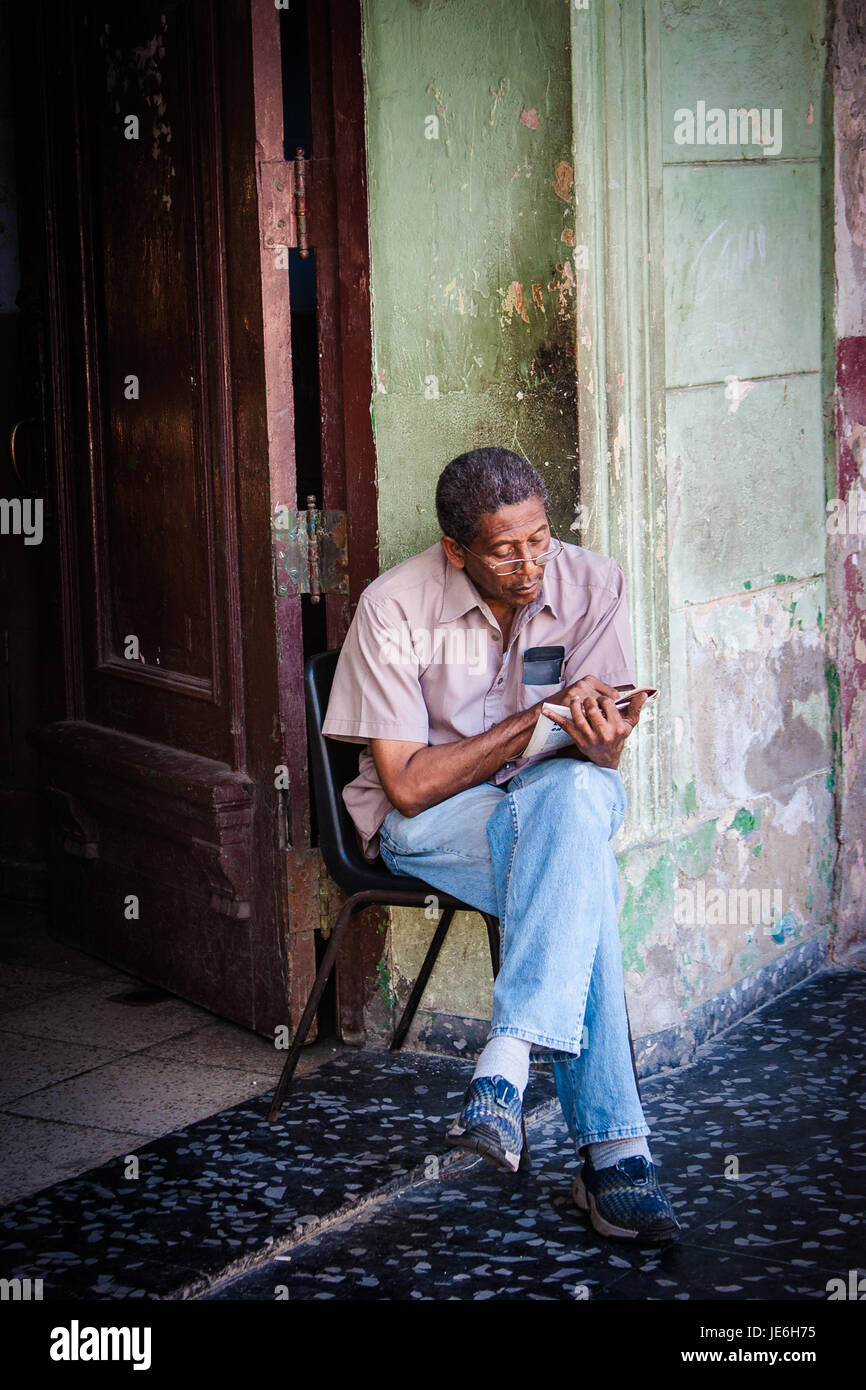 Man reading newspaper in Havana, Cuba Stock Photo