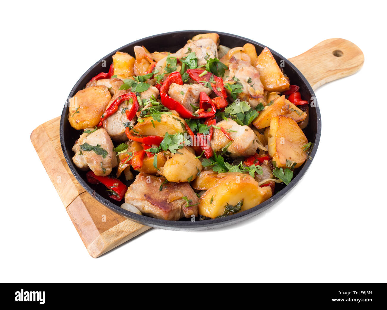 Roast pork fillets with potatoes and paprika. Isolated on a white background. Stock Photo