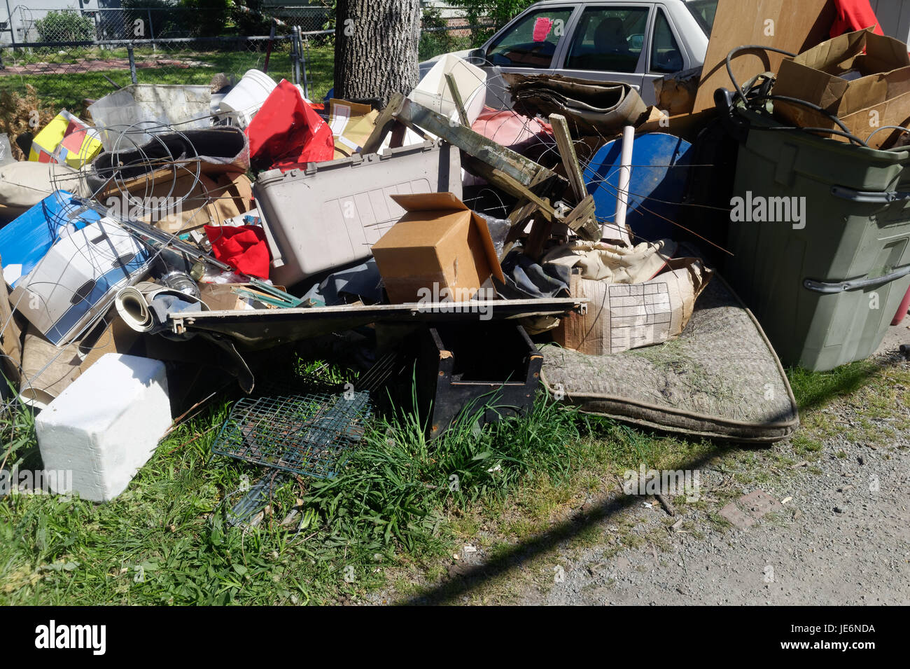 Residential neighborhood alley littered with rubbish and debris. Horizontal. Stock Photo
