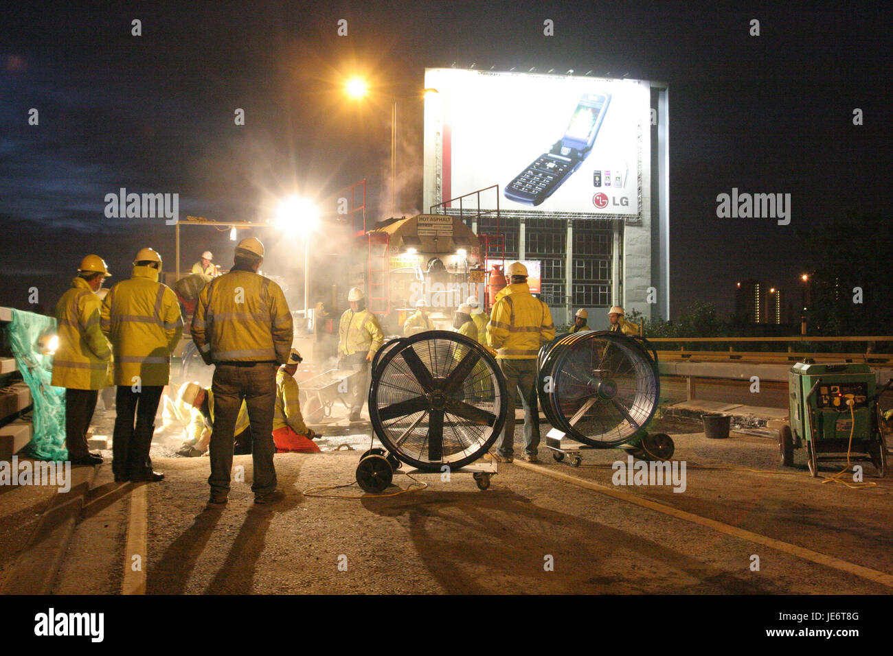 Workmen replace carriageway joints during an overnight closure of the elevated M4 Motorway west of London, UK Stock Photo