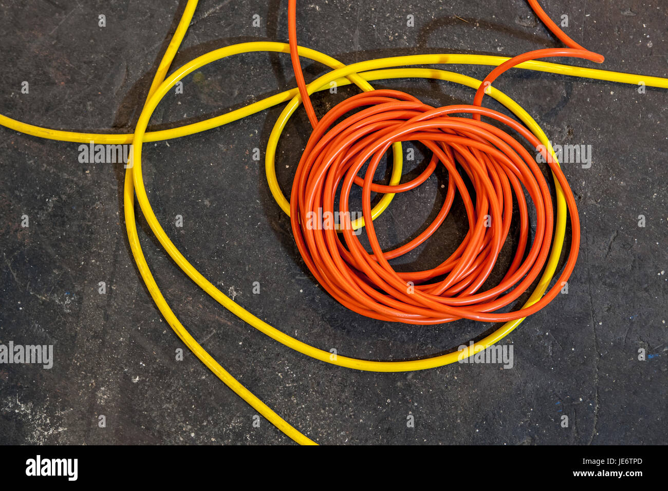 Electrical color cables lay in rolls over black ground Stock Photo