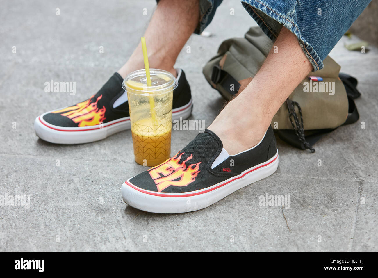 MILAN - JUNE 17: Man with black Vans shoes with flames design and orange  juice before Emporio Armani fashion show, Milan Fashion Week street style  on Stock Photo - Alamy