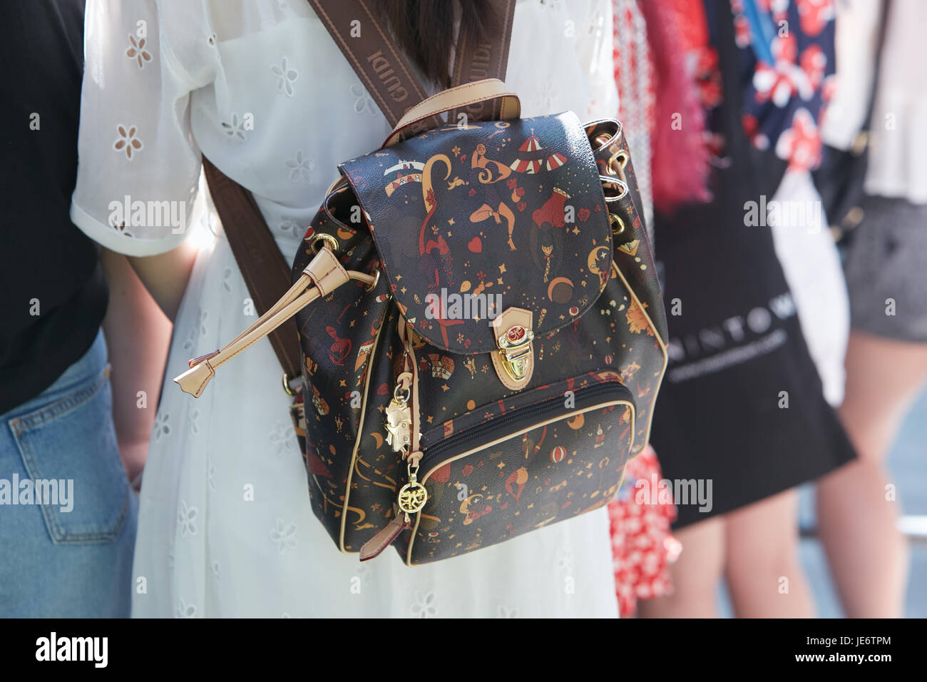 MILAN - JUNE 17: Woman with Piero Guidi backpack with human figues designs  before Emporio Armani fashion show, Milan Fashion Week street style on June  Stock Photo - Alamy