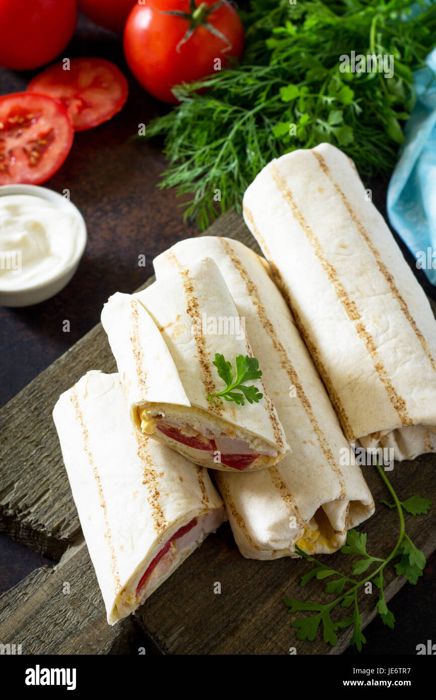 Shawarma pita bread with grilled chicken, fresh vegetables and cream