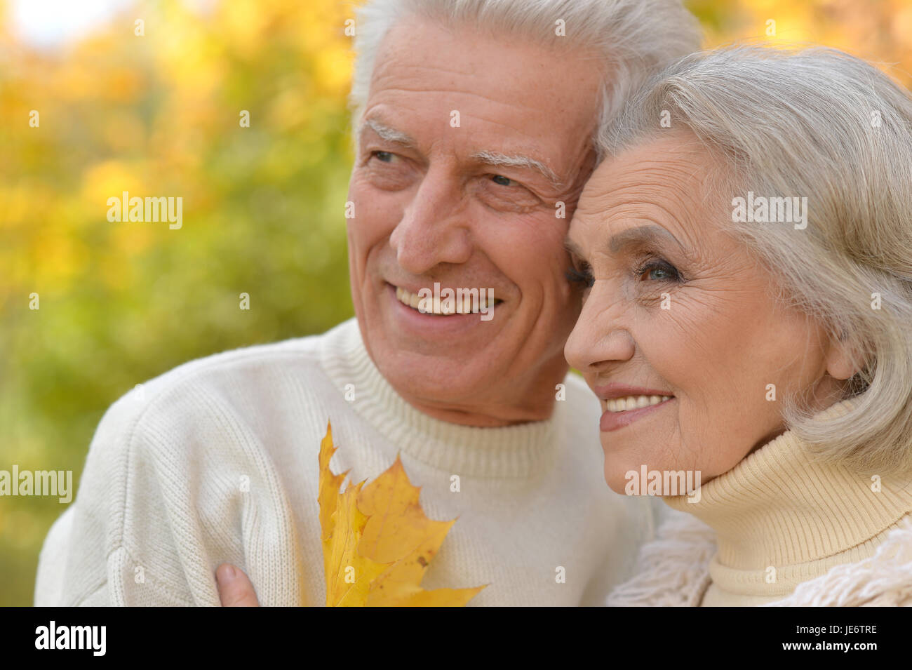 Senior couple posing in the park Stock Photo - Alamy