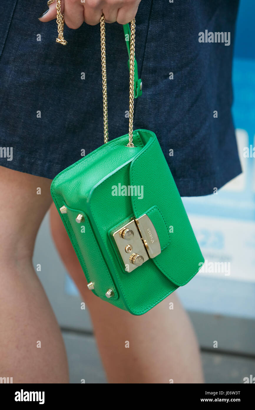 MILAN - JUNE 17: Woman with green leather Furla bag with golden chain before Emporio Armani fashion show, Milan Fashion Week street style on June 17,  Stock Photo