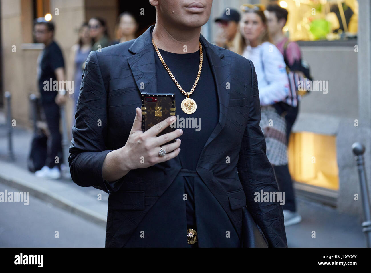 MILAN - JUNE 17: Man with Versace golden necklace and Louis Vuitton phone  cover before Versace fashion show, Milan Fashion Week street style on June  1 Stock Photo - Alamy