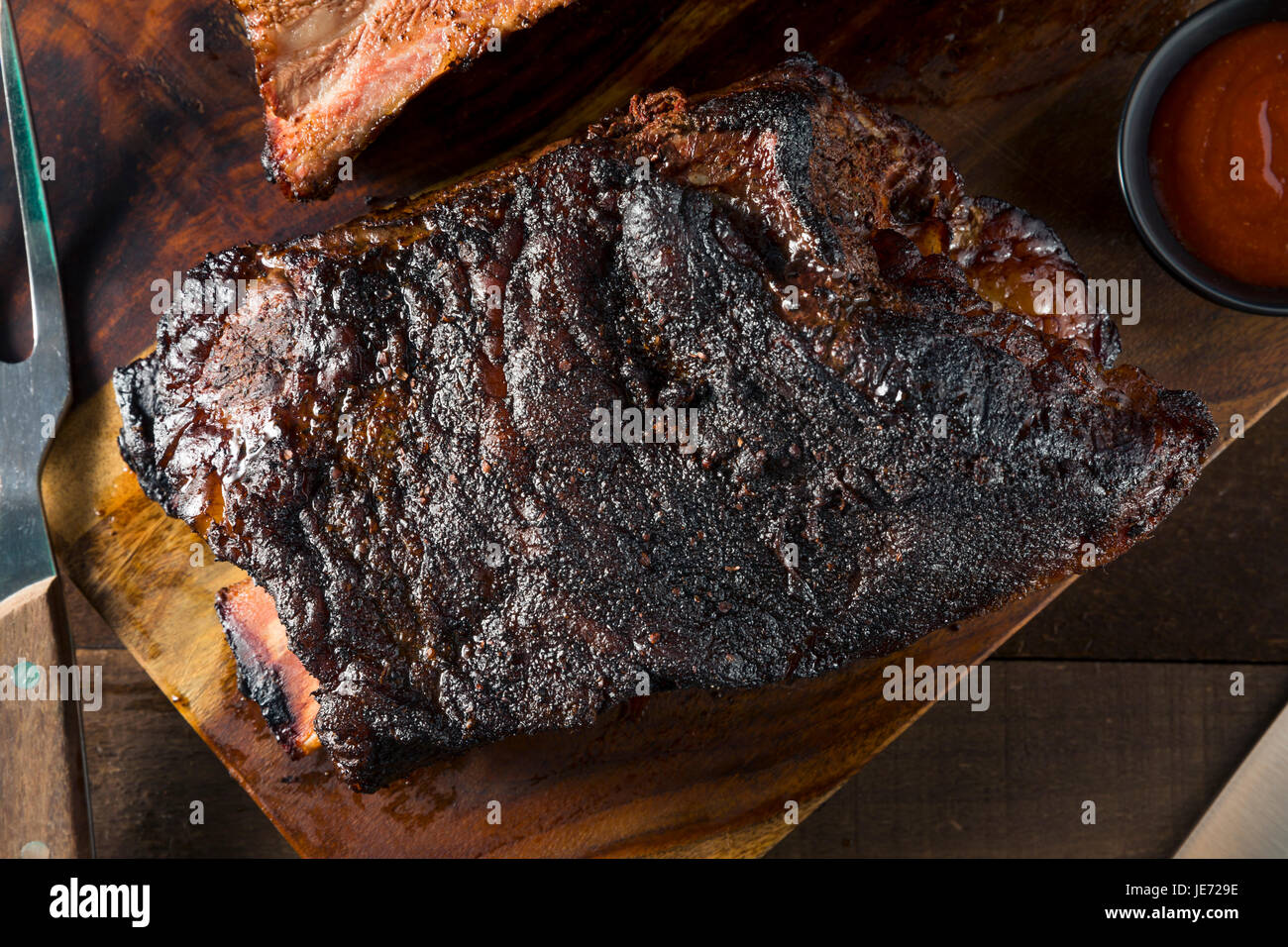 Delicious Smoked Beef Ribs with Barbecue Sauce Stock Photo