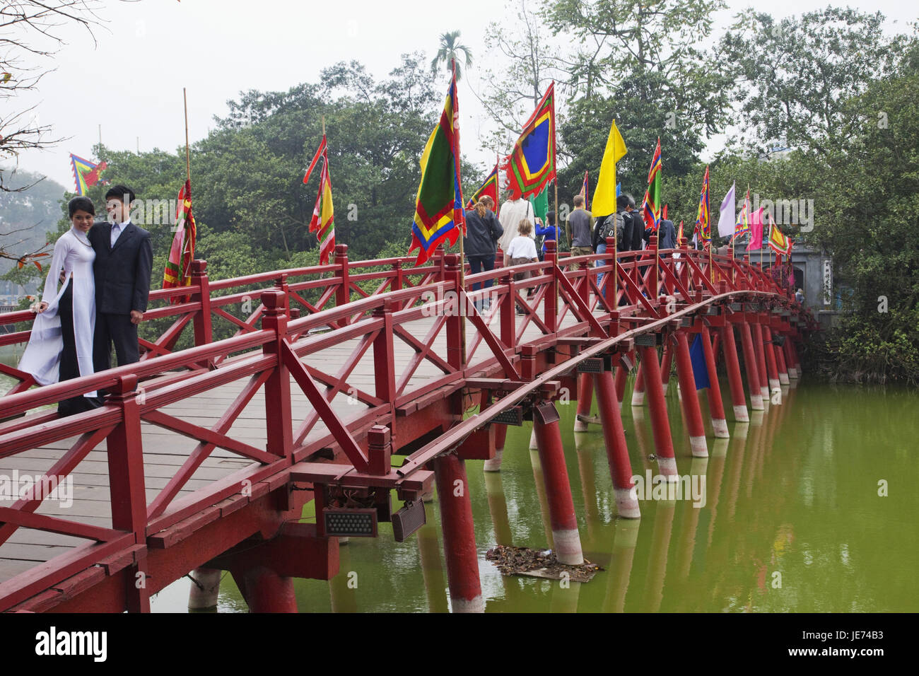 Vietnam, Hanoi, Hoan Kiem lake, Huc bridge, passer-by, Stock Photo