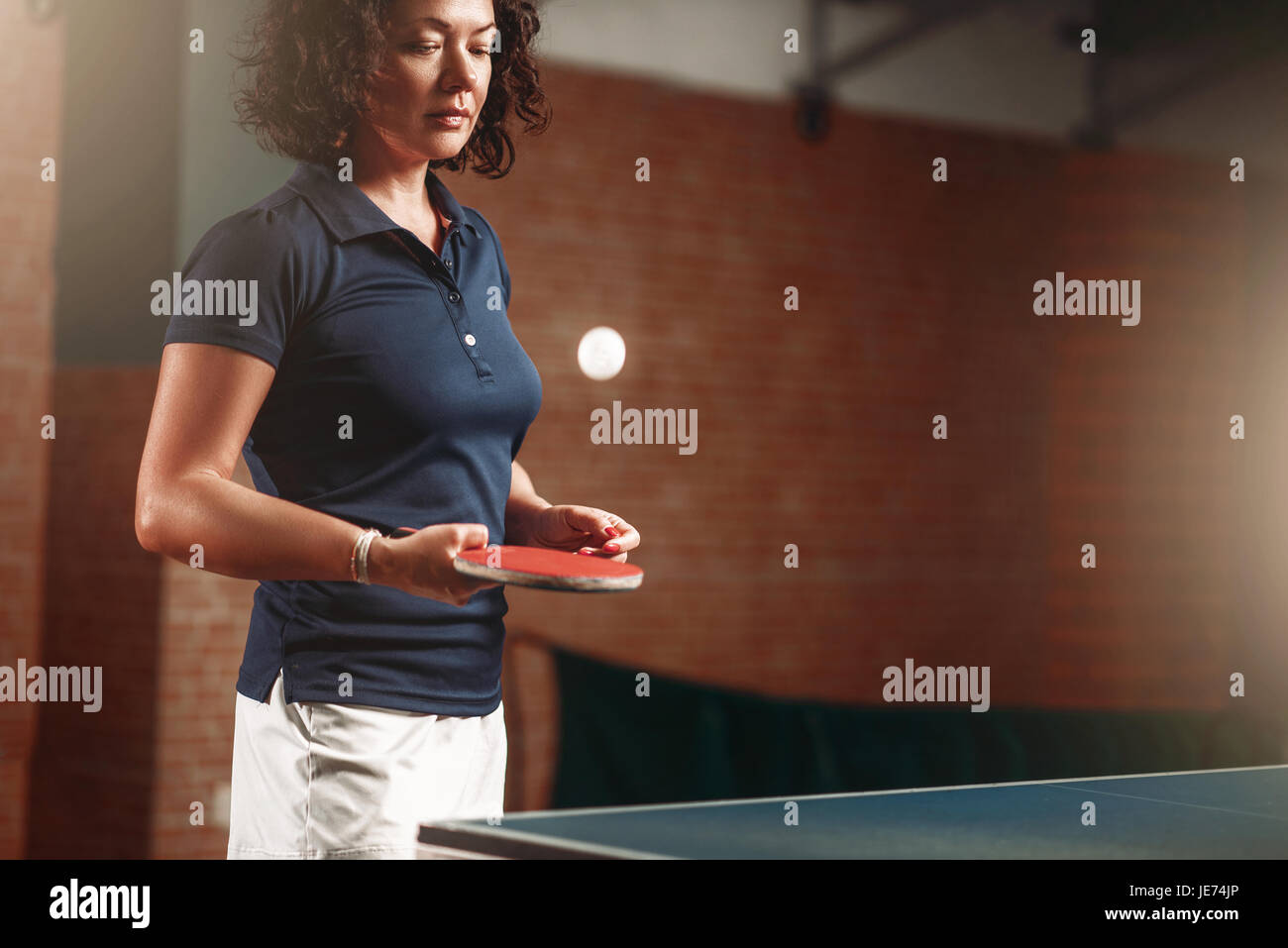 Table tennis, female player with racket hits ball. Ping pong training
