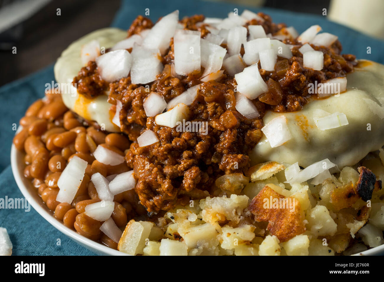 Unhealthy Homemade Beef Garbage Trash Plate with Potatoes Beans