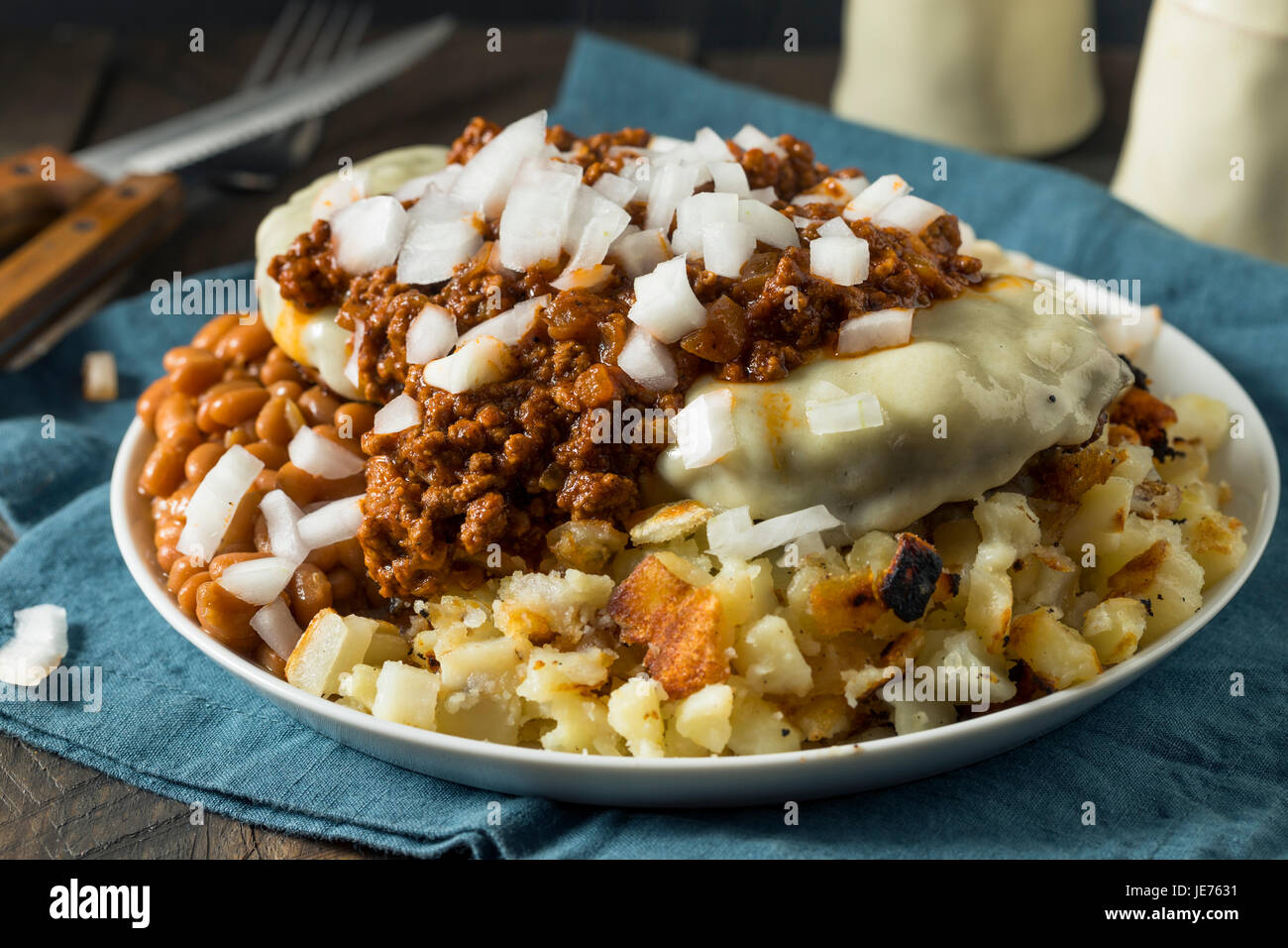 Unhealthy Homemade Beef Garbage Trash Plate with Potatoes Beans