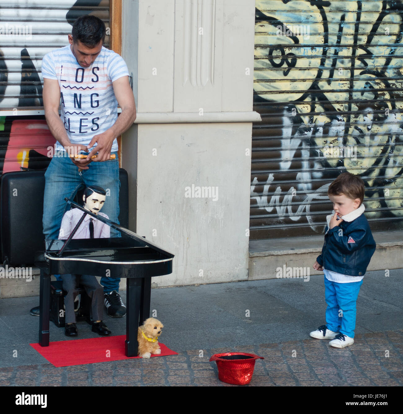 Street performer with puppet pianist and dog with a fascinated audience in Bilboa northern Spain Stock Photo