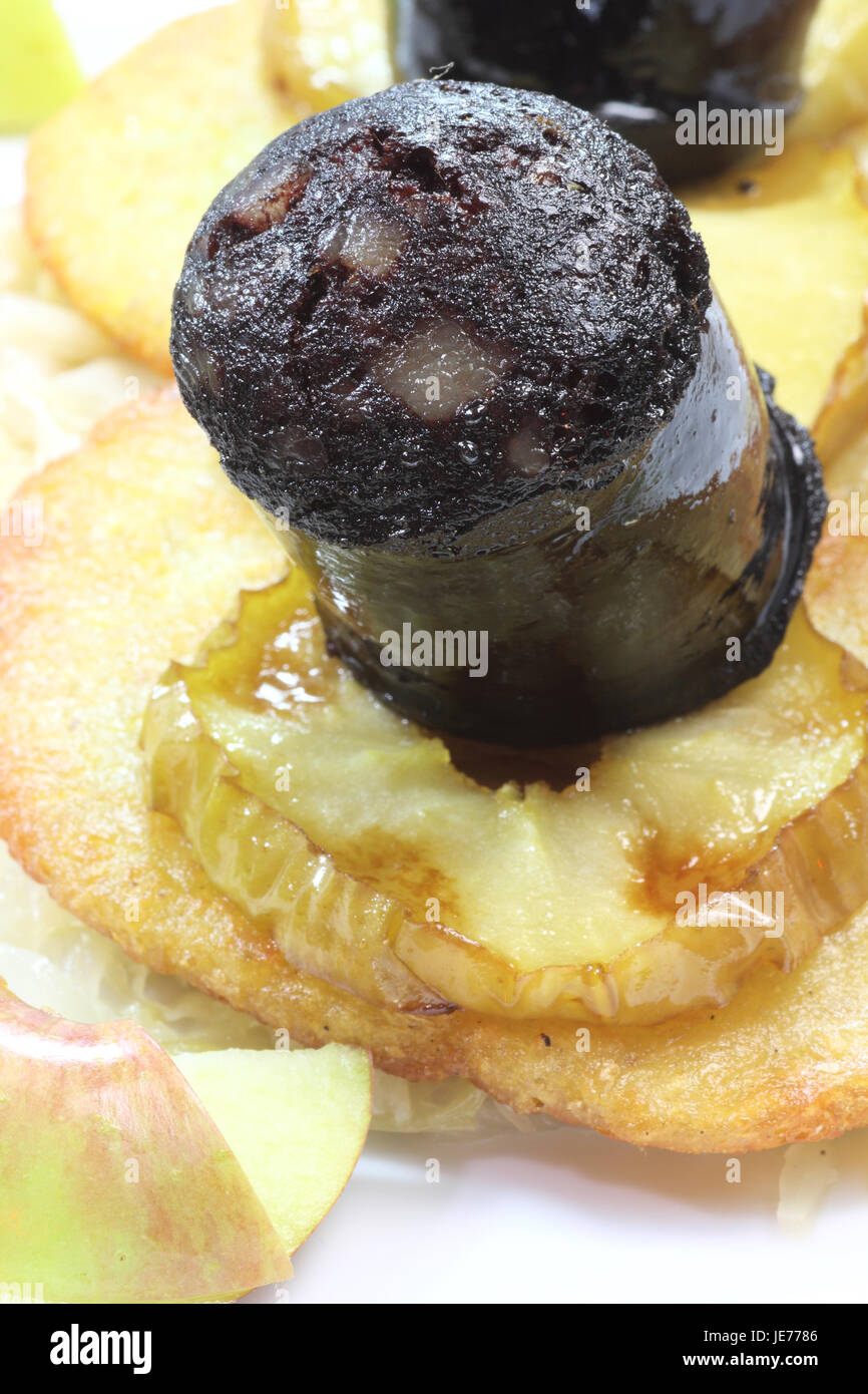 Black Pudding with apple slice potato pancake and sauerkraut.Traditional german meal called