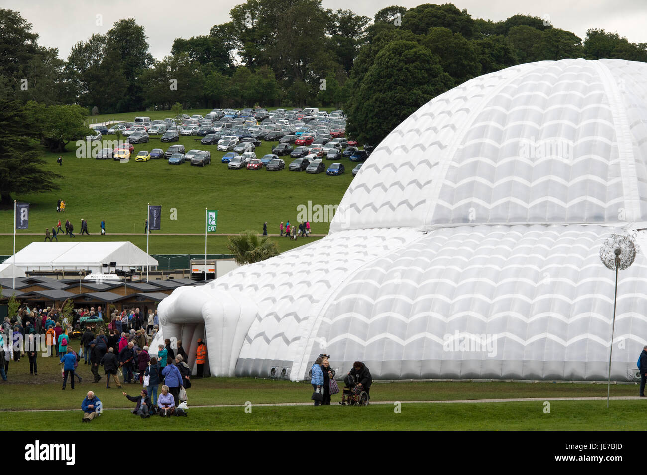 First RHS Chatsworth Flower Show (entrance to huge inflatable dome tent, car park & people walking about - Chatsworth House, Derbyshire, England, UK. Stock Photo