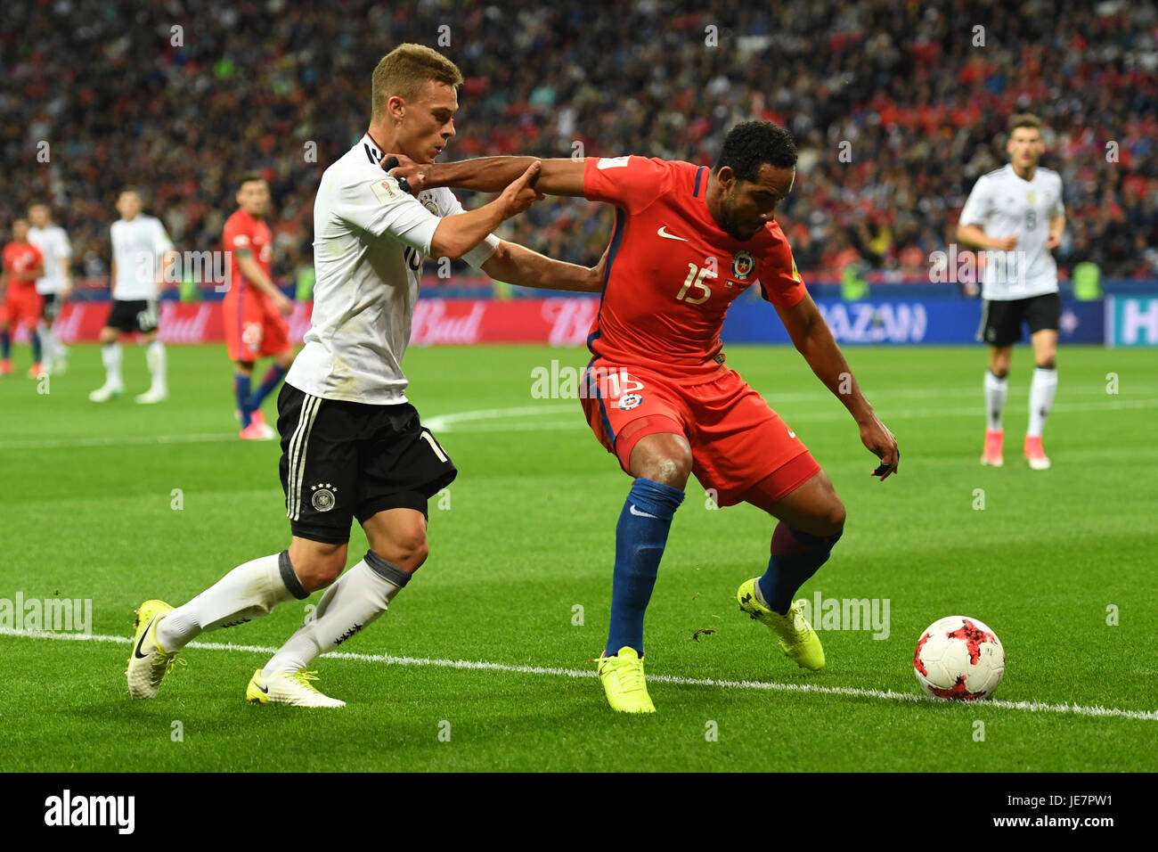 Kazan, Russia. 22nd June, 2017. Germany's Joshua Kimmich (L) and Chile's Jean Beausejour vie for the ball during the Group B preliminary stage soccer match between Chile and Germany at the Confederations Cup in Kazan, Russia, 22 June 2017. Photo: Marius Becker/dpa/Alamy Live News Stock Photo