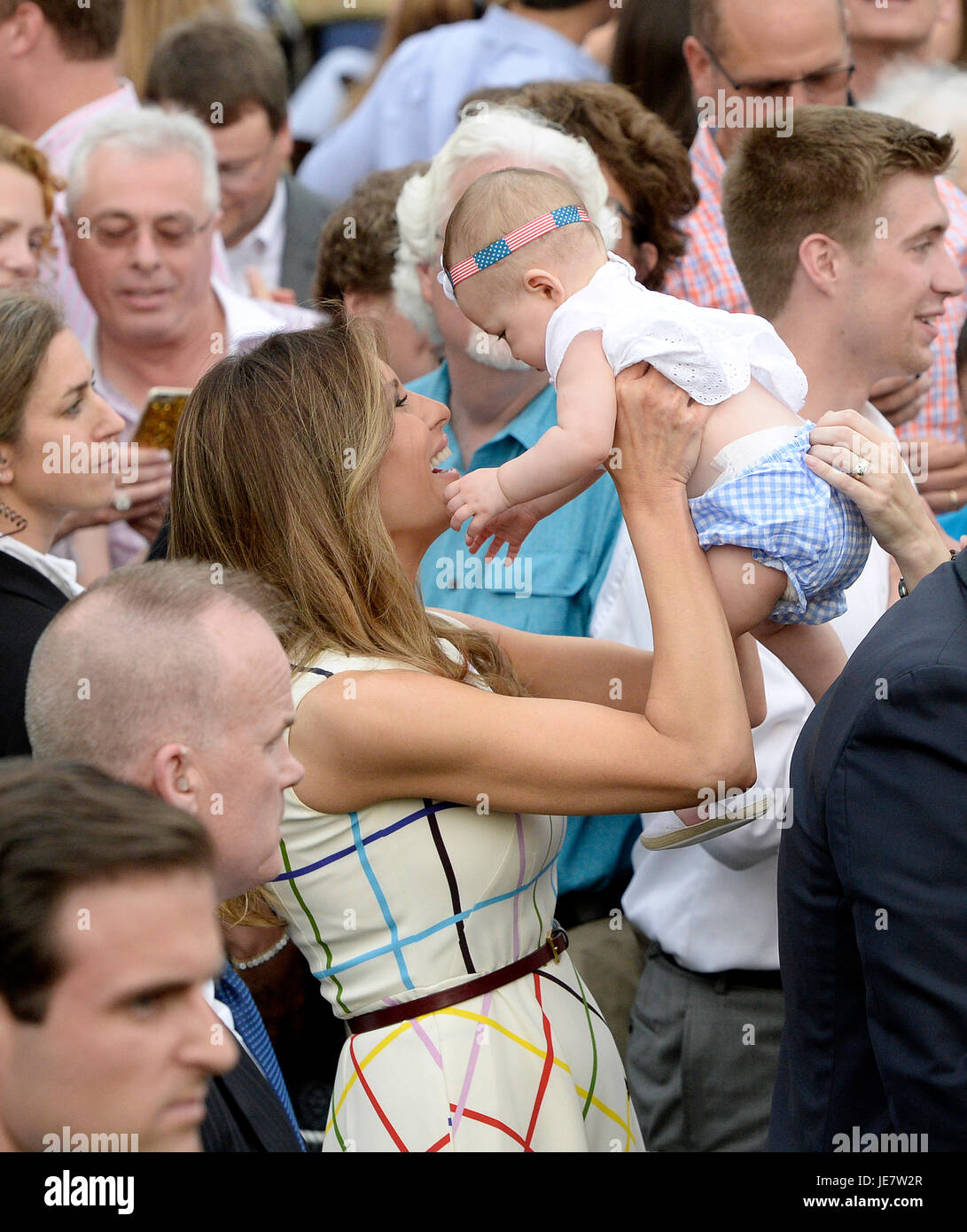 First Lady Melania Trump holds a baby during the Congressional Picnic on  the South Lawn of the White House in Washington, DC, on June 22, 2017.  Credit: Olivier Douliery - Pool via
