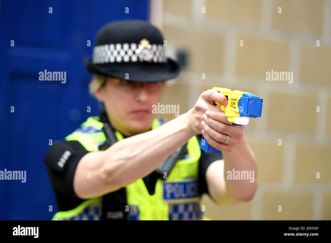 Taser, police officer using a taser during training. The focus of the event is to demonstrate the transparency around Dorset Police's use of force and the challenges involved, along with an overview of equipment and the skills that improve public and officer safety.  This comes ahead of the publication of use of force data by individual police forces nationally at the end of July. An officer demonstrates using an X26 Taser Credit: Finnbarr Webster/Alamy Live News Stock Photo