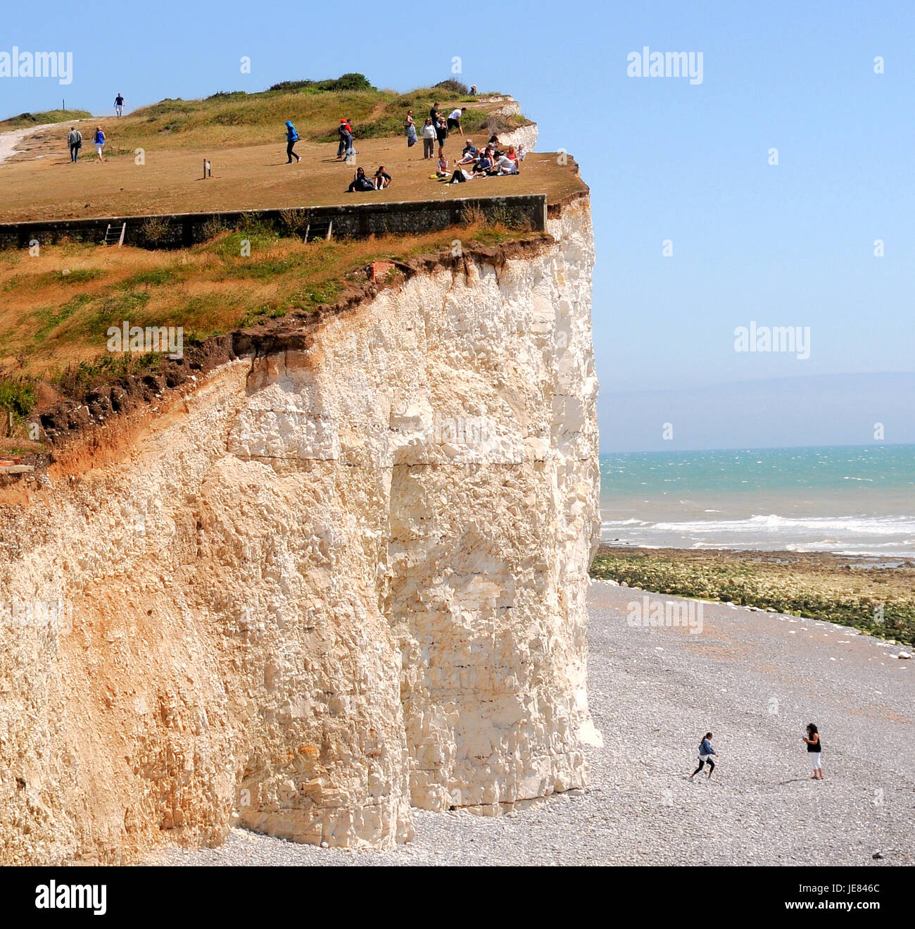 East Sussex, UK. 23rd June, 2017. Warnings have been issued after recent spate of Rockfalls along the Chalk Cliffs particularly at Seaford.These holiday makers at Birling Gap seem unaware.. Stock Photo