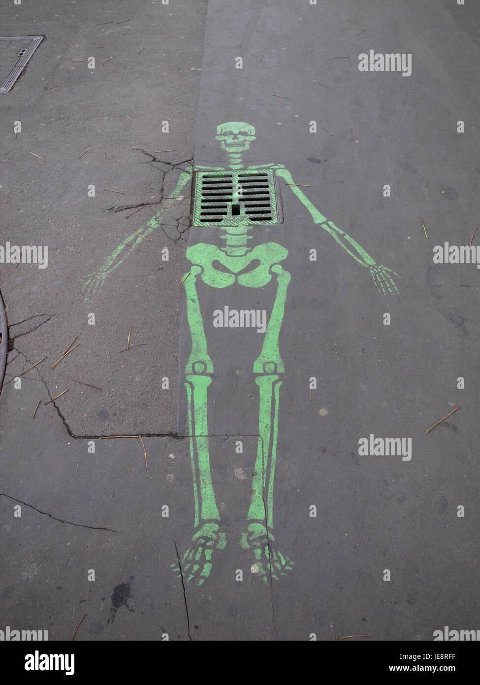 PARIS FRANCE - STREET ART : GREEN SKELETON PAINTED ON THE PAVEMENT © Frédéric BEAUMONT Stock Photo