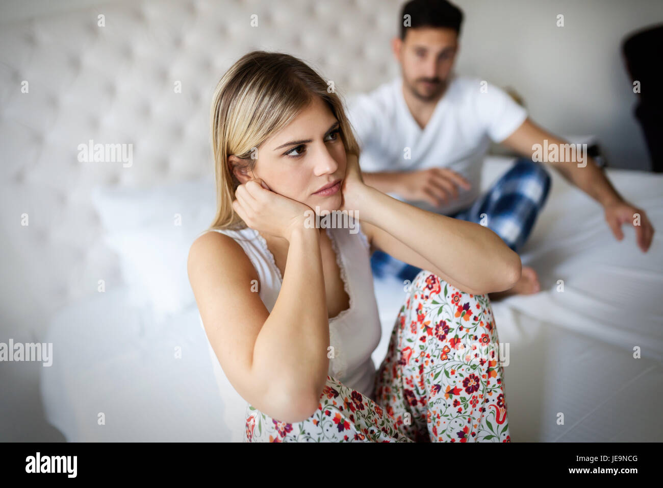 Young couple in bed having problems and crisis Stock Photo