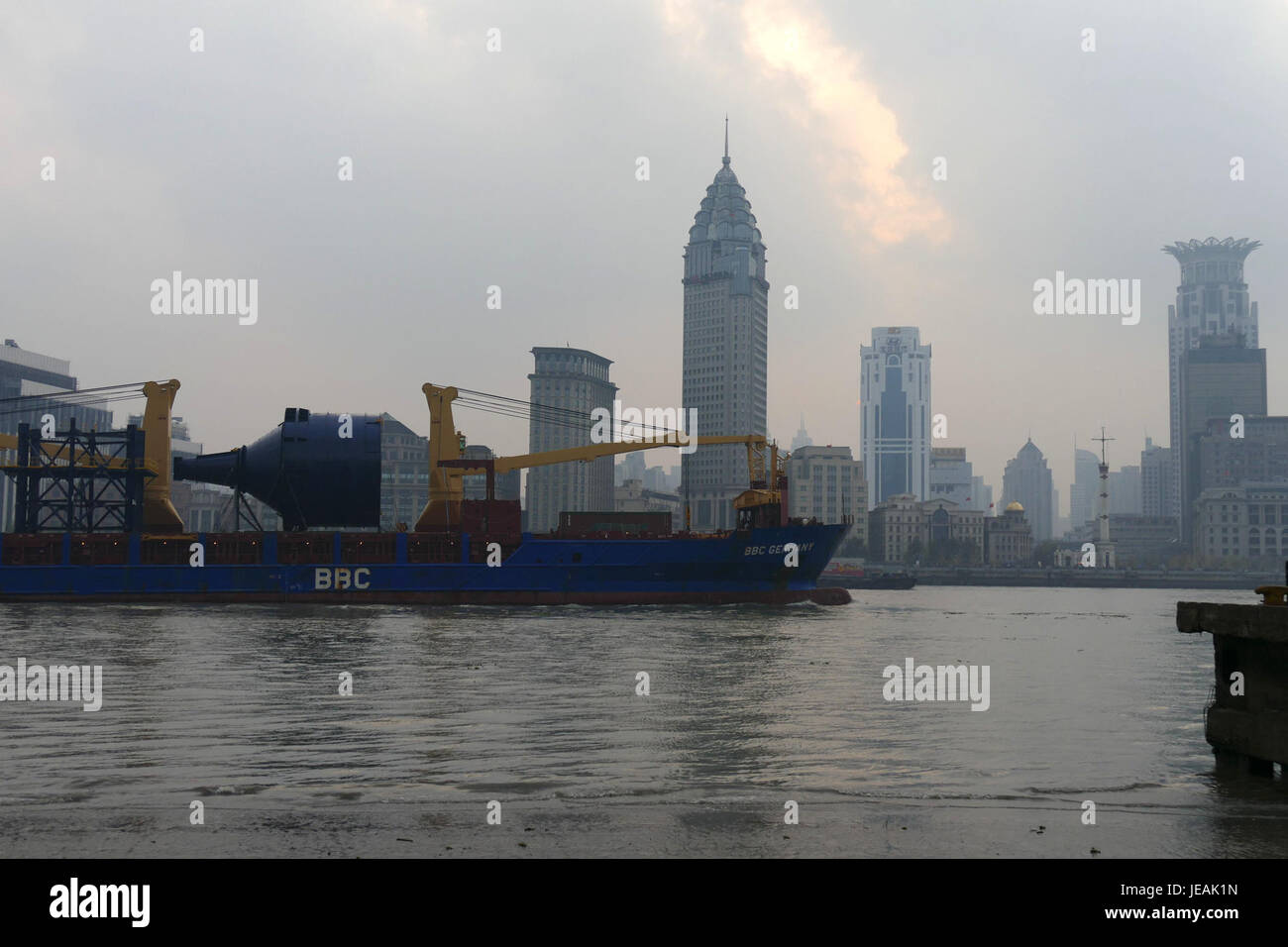 This photograph captures ships navigating the Huangpu River in Shanghai, a major waterway in the city. The image reflects the bustling port activities and the dynamic environment of Shanghai's waterfront. Stock Photo