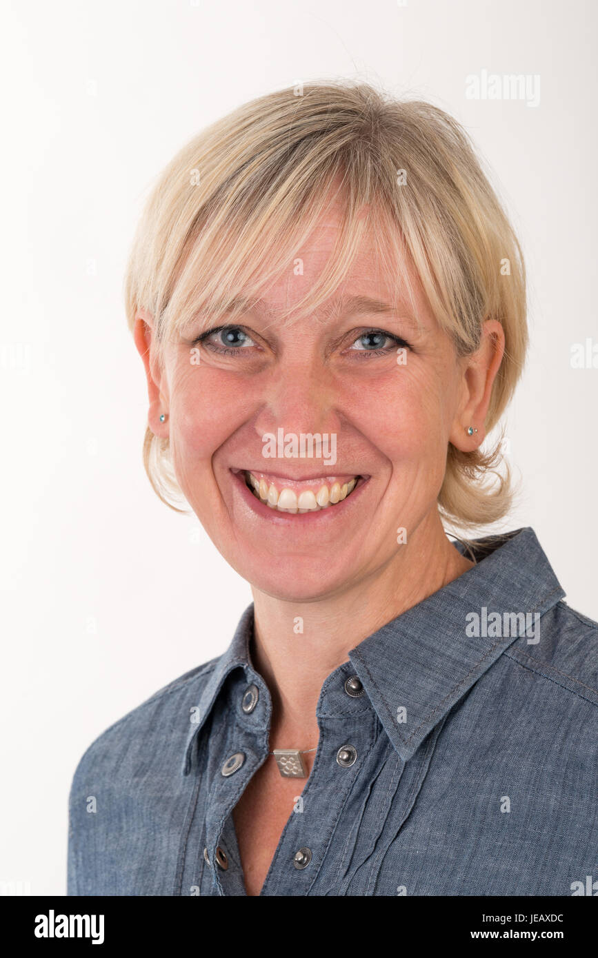 headshot portrait of a beautiful blonde european middle age women dressed in gray business jacket - studio shot in front of a white background Stock Photo