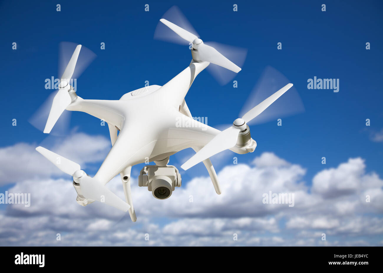 Unmanned Aircraft System (UAV) Quadcopter Drone In The Air. Stock Photo