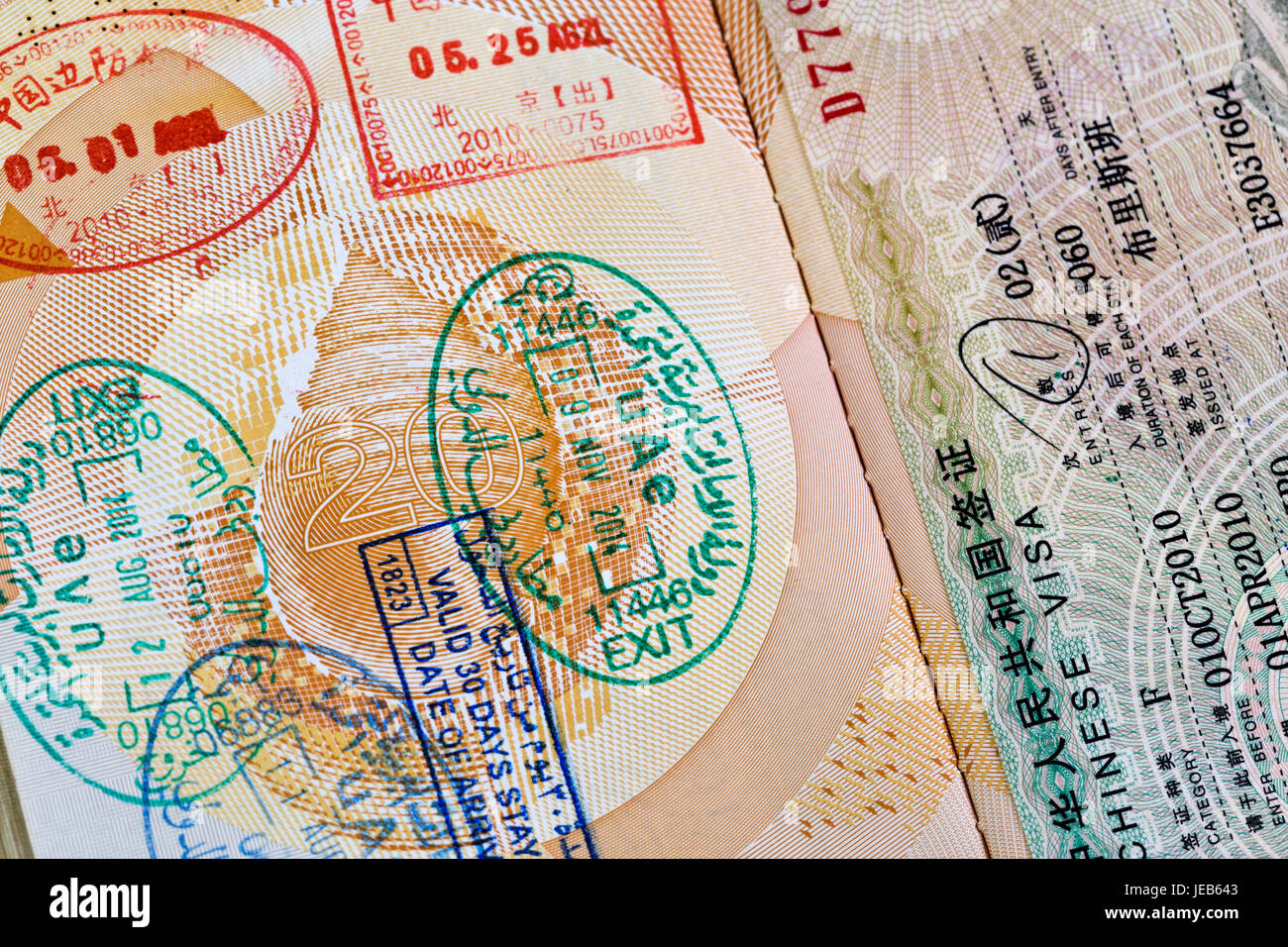 Various arrival and departure stamps on a passport and country visa