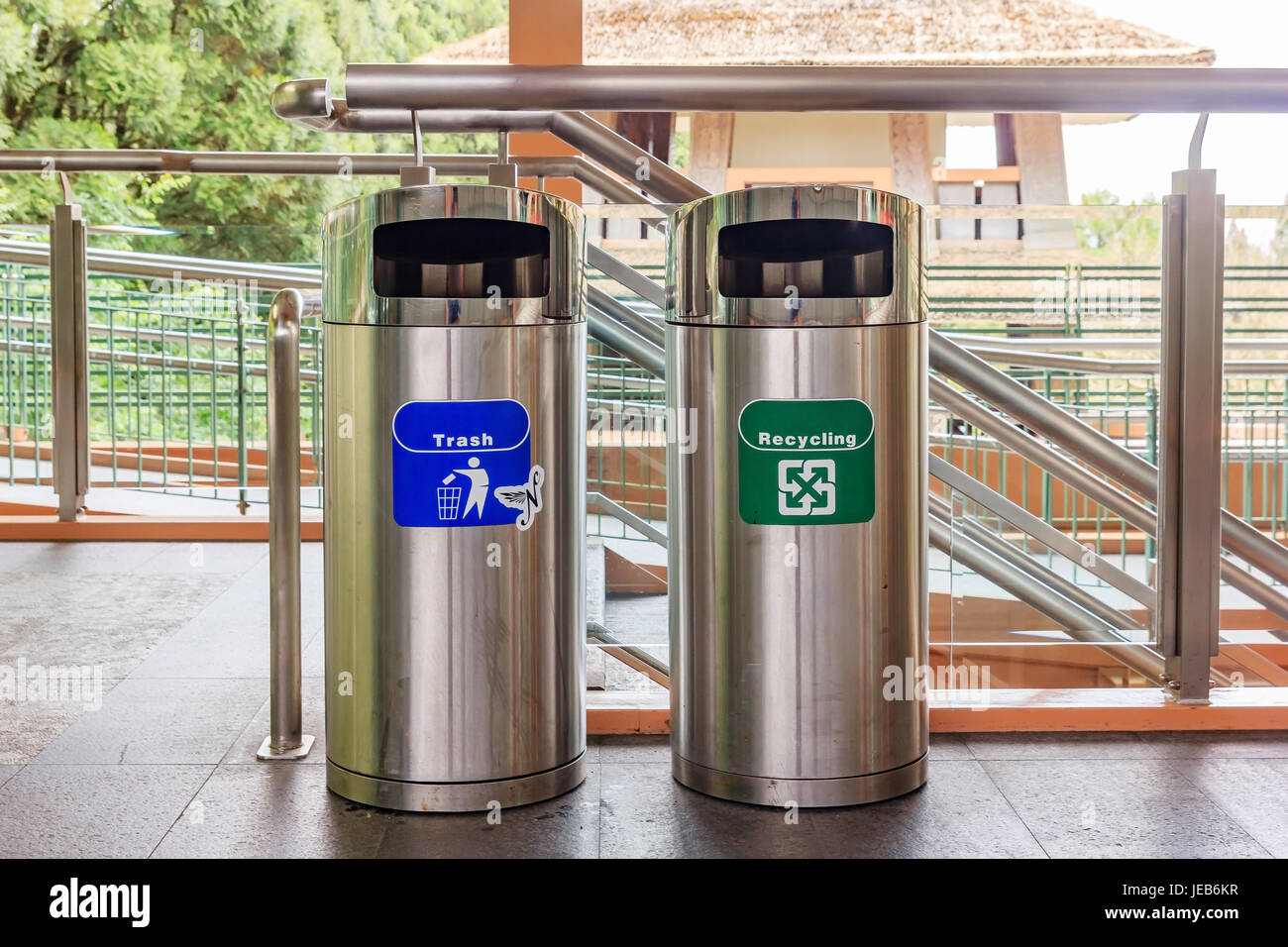 Stainless steel trash and recycle bins. types of rubbish, separated by its color, (Blue)general waste. (Green) for recyclable waste. Stock Photo