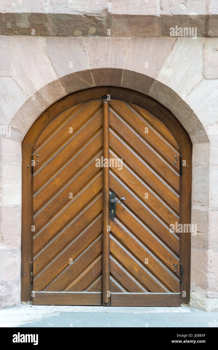 An old wooden door in a stone wall from the front Stock Photo - Alamy