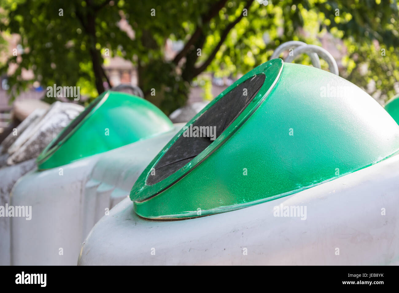 Several grey green glass containers for recycling close up Stock Photo