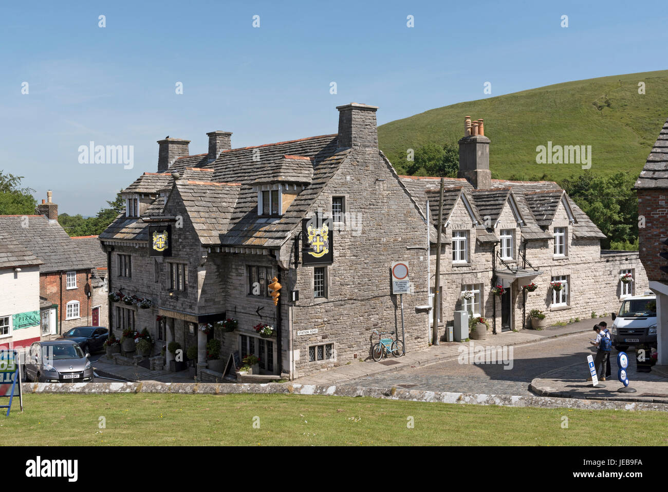 The Bankes Arms Hotel in Corfe Castle Dorset England UK overlooked by the East Hill. Stock Photo