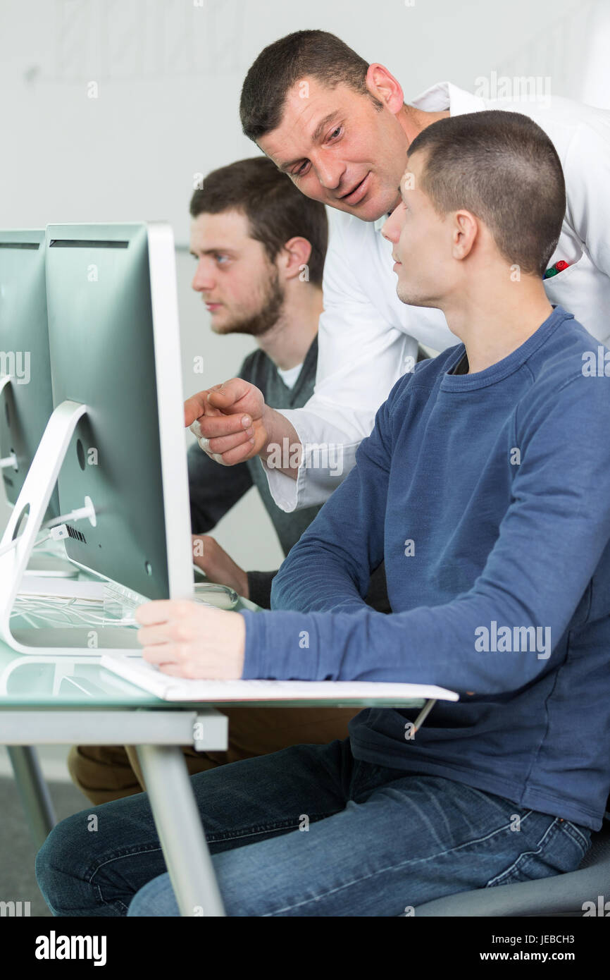 three students in technology class Stock Photo