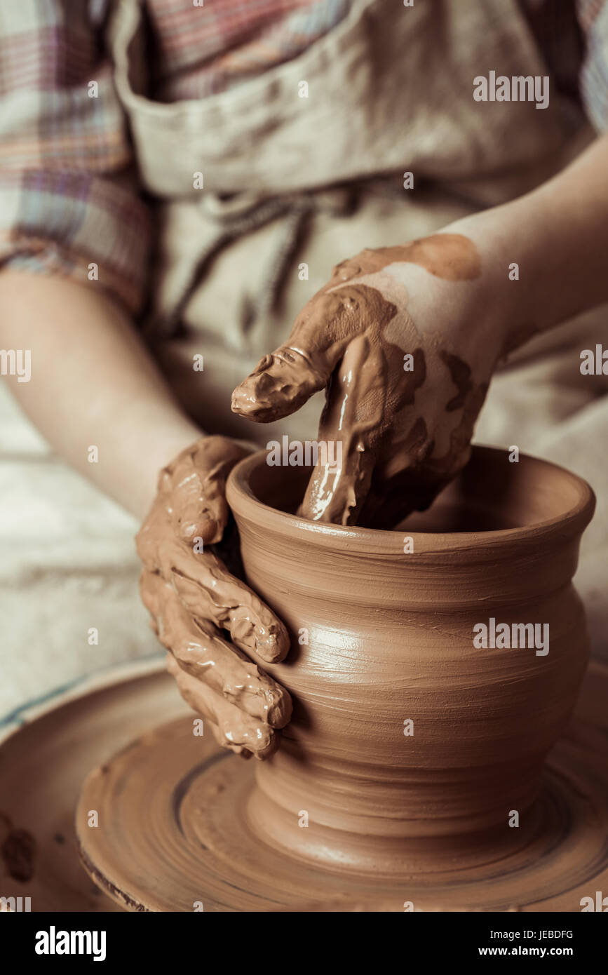 Close up of child hands working on pottery wheel at workshop Stock ...