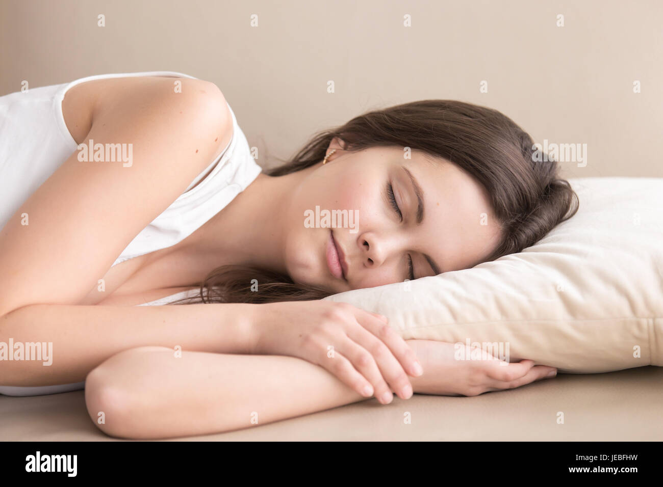 Tired beautiful lady resting on sofa at home Stock Photo