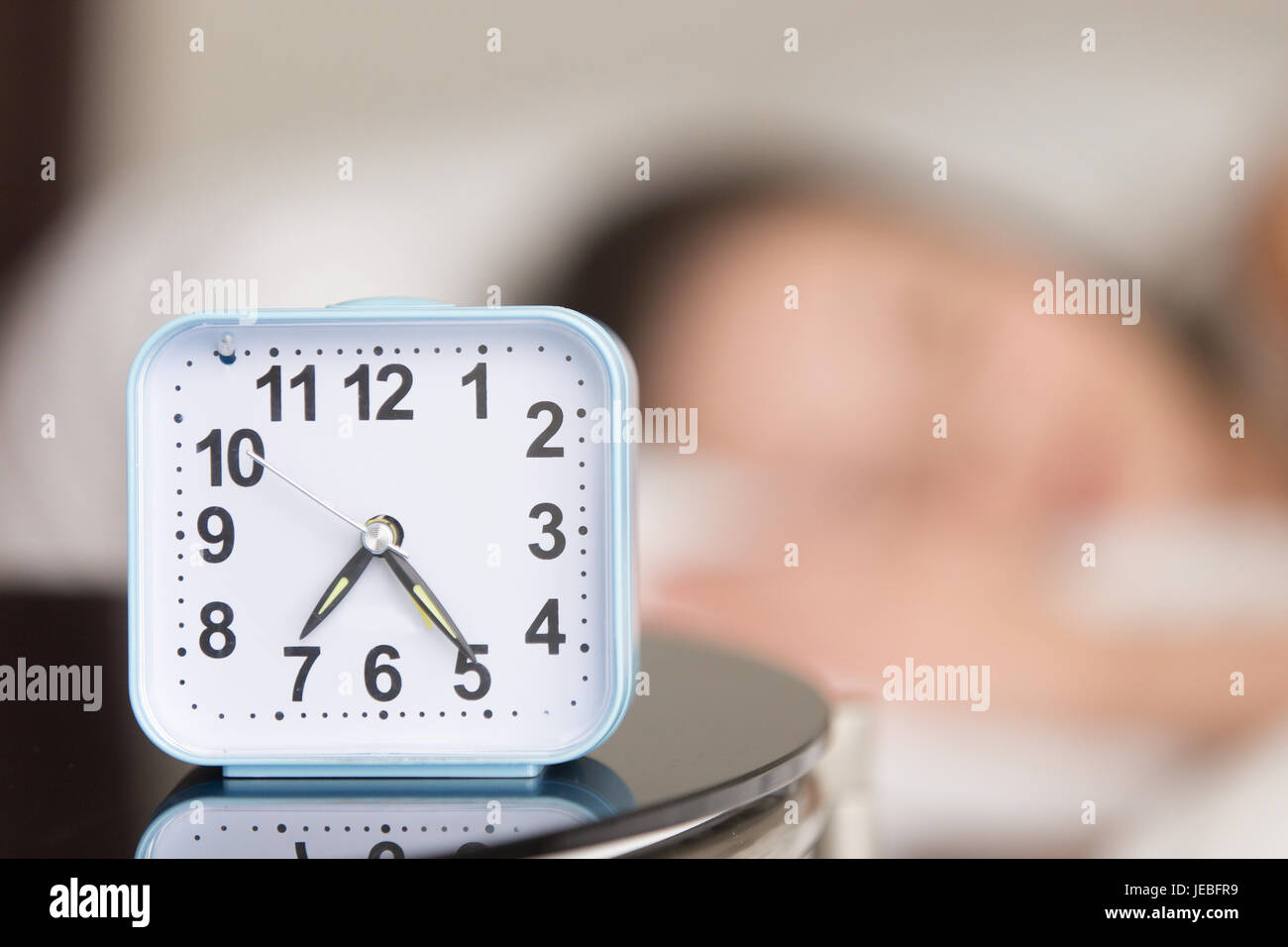 Close up image of alarm clock on bedside table Stock Photo