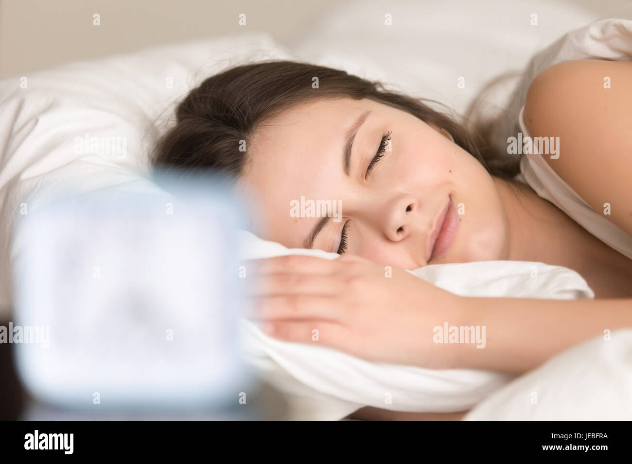 Woman relaxing in bed before going at work Stock Photo