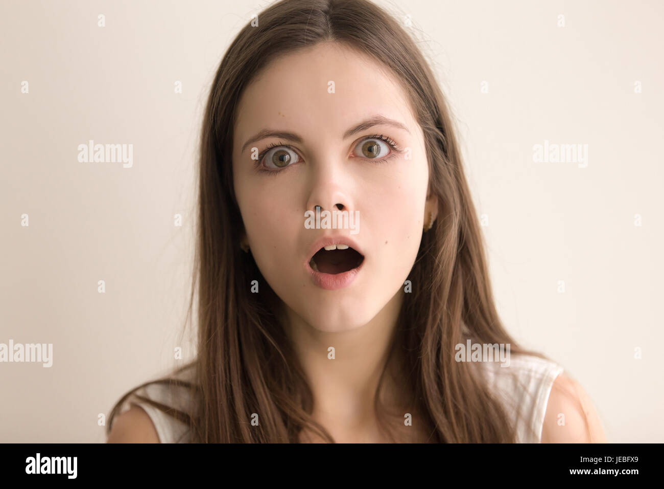 Emotive headshot portrait of puzzled young woman Stock Photo