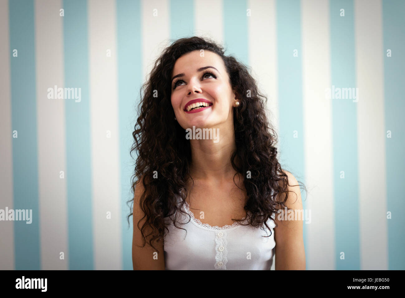 Portrait of young beautiful woman with curly hair Stock Photo
