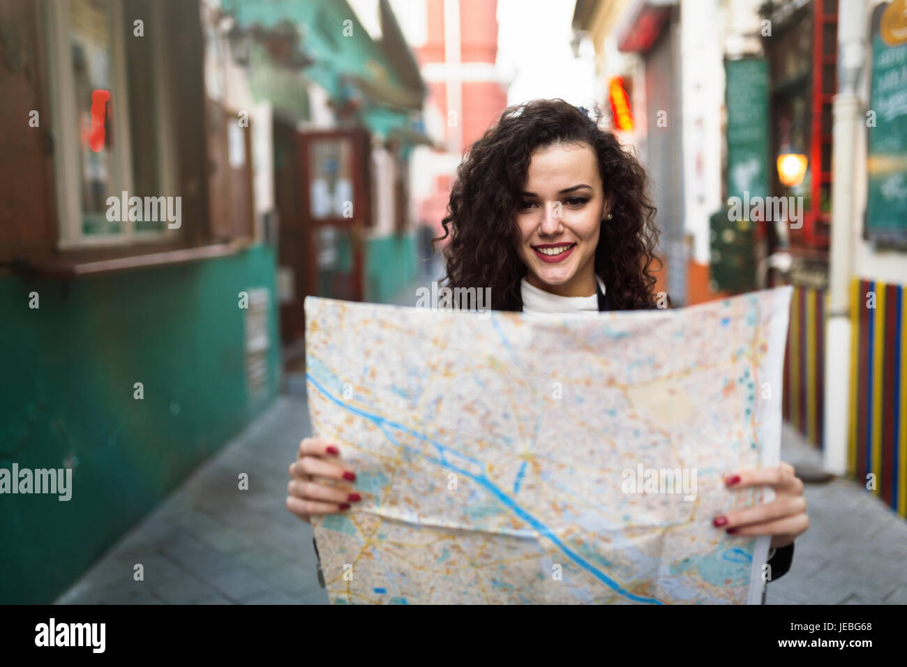 Young beautiful woman looking at city map Stock Photo