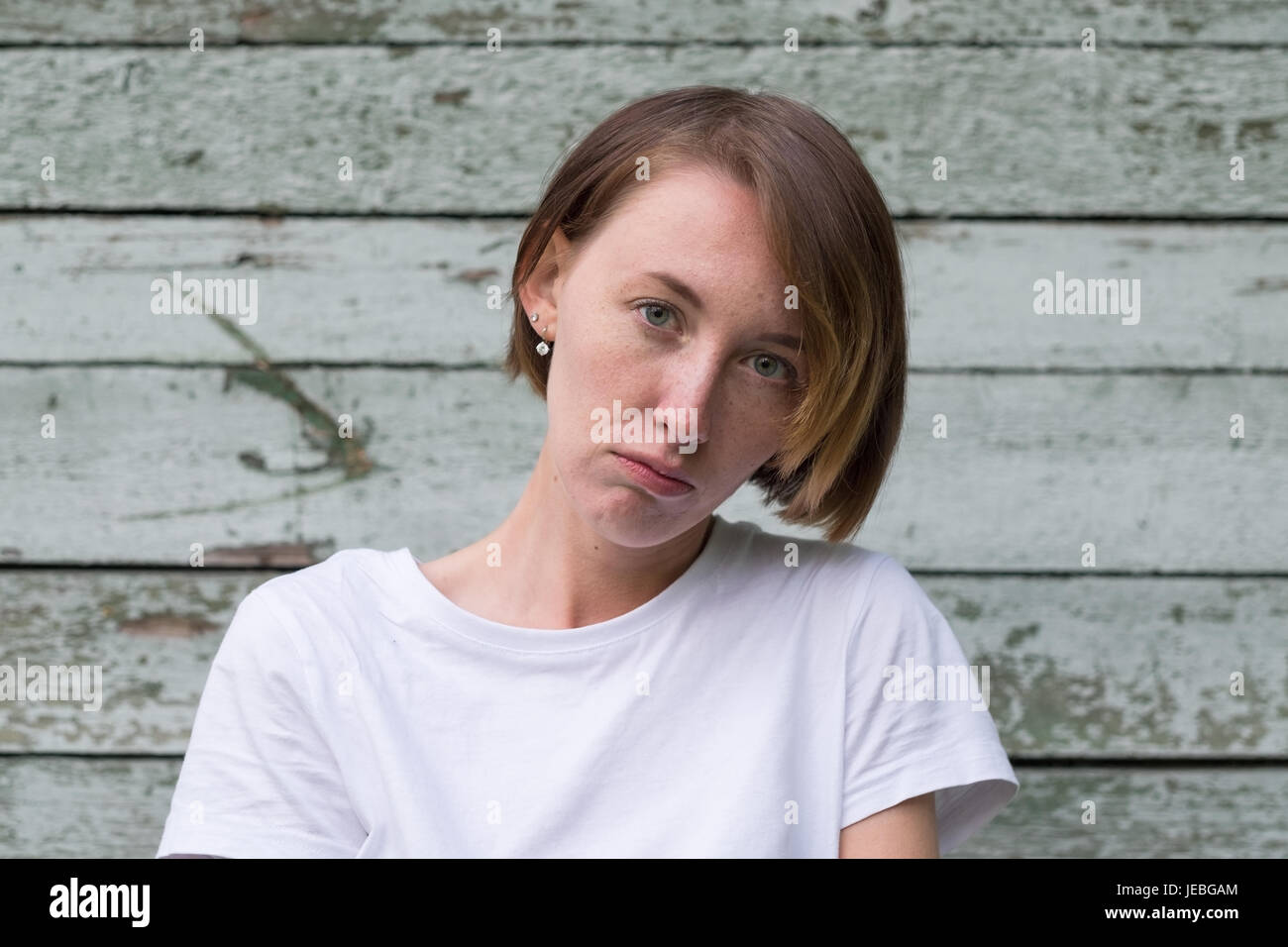 portrait of beautiful young angry woman in white t-shirt Stock Photo