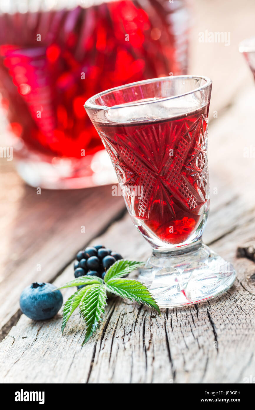 Sweet liqueur with berry fruits and alcohol in summer Stock Photo - Alamy