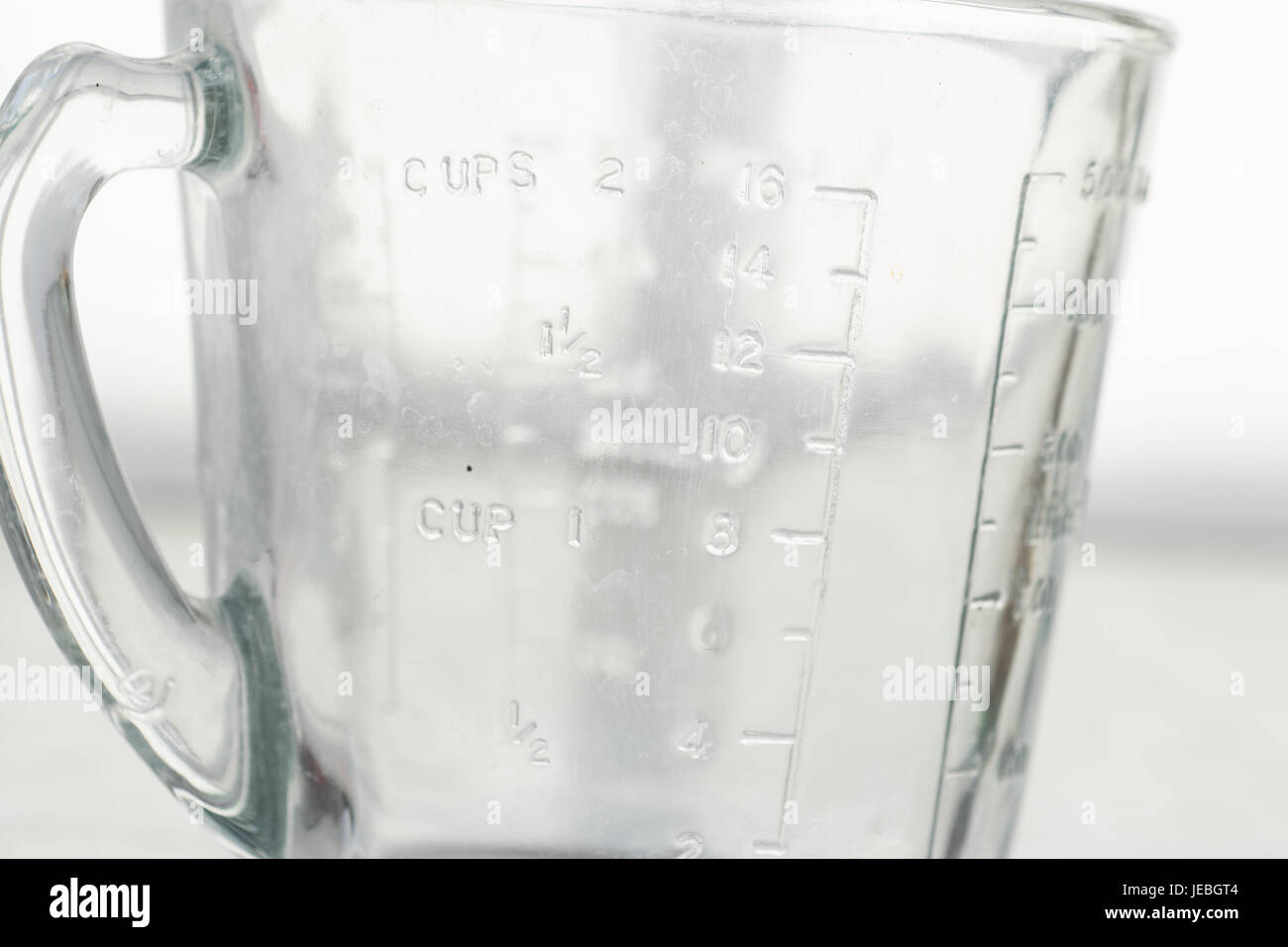 Measuring mug on a white background Stock Photo