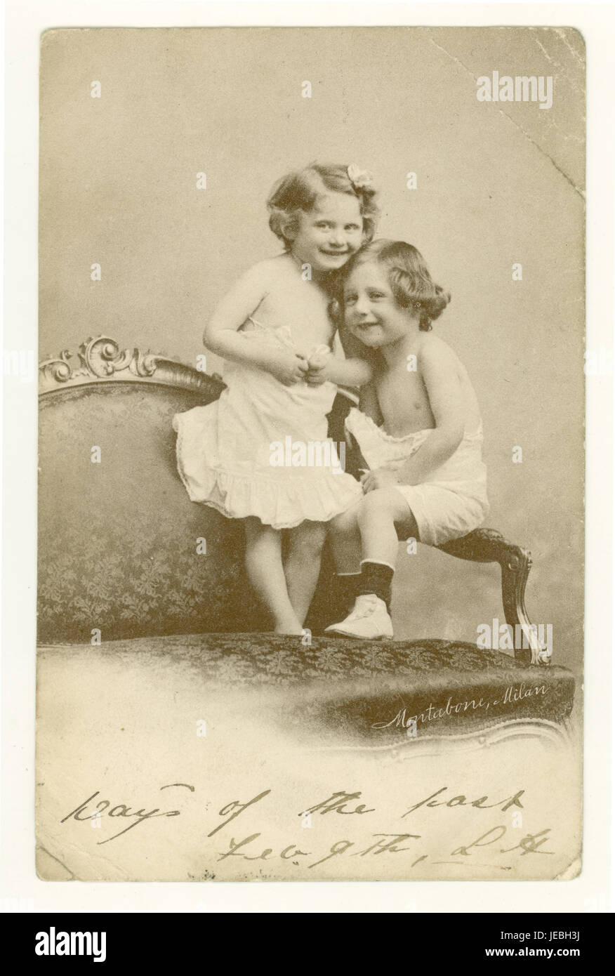 Original Edwardian era charming greetings postcard of two cute young children cuddling, posted February 1904, Manchester, England, U.K. Stock Photo